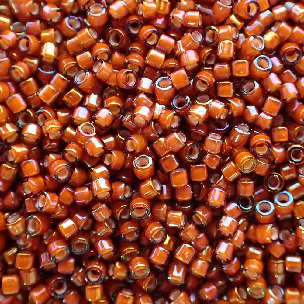 Delica 11 - Topaze foncée lignée blanche AB (4 g)