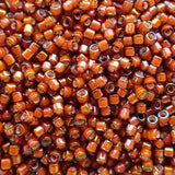 Delica 11 - Topaze foncée lignée blanche AB (4 g)